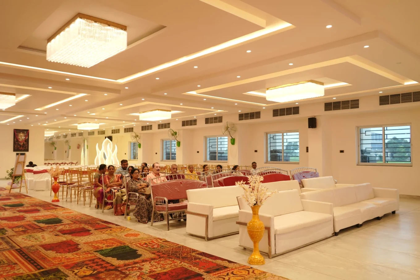 Banquet hall interior in Tarsa Maharashtra – Shree Saishwar Grand Hall with chandeliers and guest seating